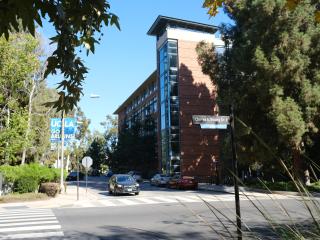 A car driving on Charles E. Young Drive passing the Engineering V Building. 